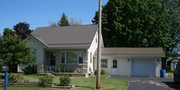 Full view of home with metal roof